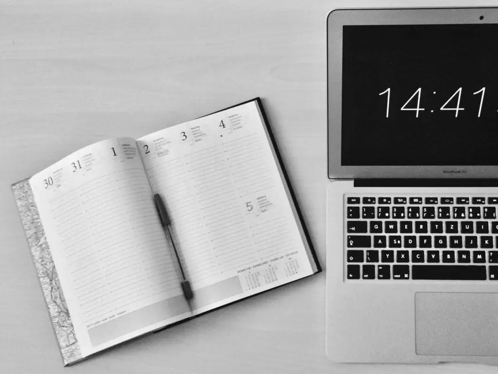A MacBook and a notebook