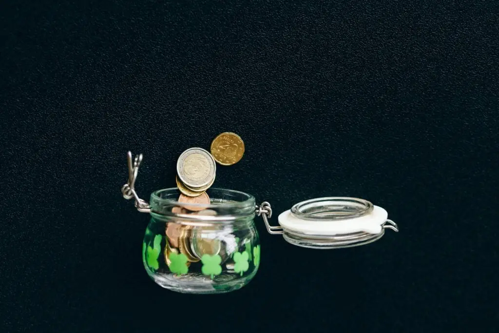 A small jar with a few pounds spilling out